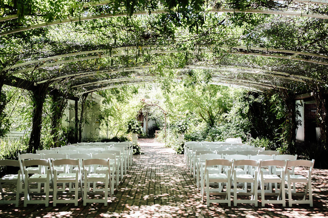 Potters Receptions MWB37_Potters Receptions_pagola_brick path_outdoor venue_wedding aisle_white chairs